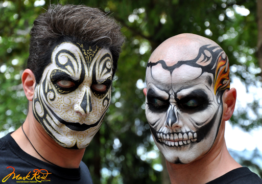 two men in stylized skull theamed painted masks